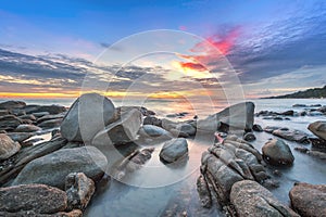 Sunset over the sea. Stone on the foreground