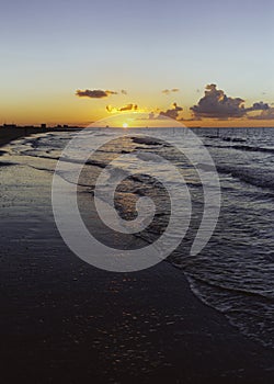 Sunset over sea waves, Cloudy orange sunset over sea water.