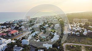 Sunset over Seagrove beach neighborhood with row of white painted vacation homes, condo buildings, residential units along county