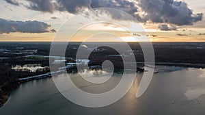 Sunset Over Serene Lake with Dramatic Cloudy Sky Aerial View