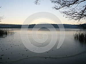 Sunset over the shore of a frozen lake near Sternberg