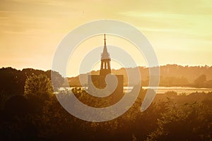 Sunset over the silhouette of the tower church in a English village of Boxford, England