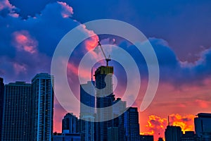 Sunset over skyscrapers, including one under new construction, in downtown Chicago.