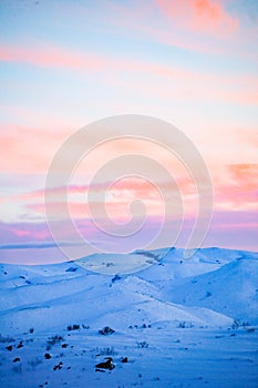 Sunset over snow capped mountains in rural Idaho