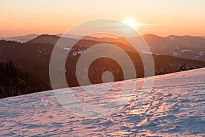 Sunset over snow covered mountains