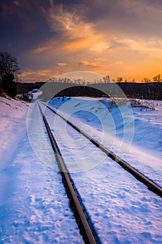 Sunset over snow-covered railroad tracks in Carroll County, Mary