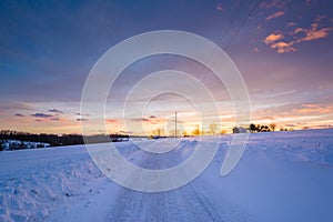 Sunset over a snow covered road  in a rural area of York County, Pennsylvania