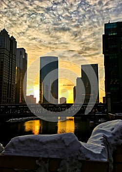 Sunset over a snowy Chicagoland and Chicago River in winter.