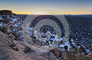 Sunset over snowy sandstone cliffs