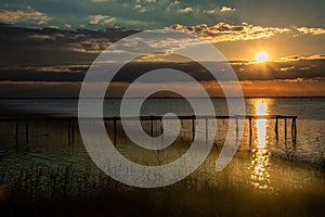 Sunset over Stilt house and fishing nets along the Po Delta. Italy