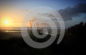 Sunset over the stream flowing into the Atlantic Ocean near Gulpilhares, Porto, Portugal, January 2018