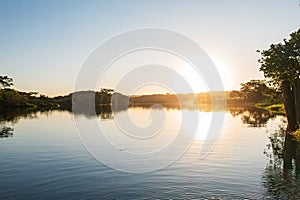 sunset over stretch of Tiete River photo