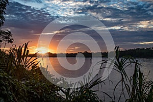 Sunset over a river in the Amazonas Region, Peru photo