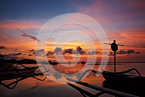 Sunset over traditional fishing boats on Bali