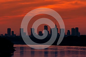 Sunset over the Warsaw city buildings by the Vistula river in Poland.