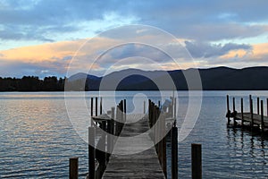 Sunset over the water, with long wood piers reaching into the distance