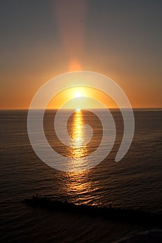 Sunset over water with wave break