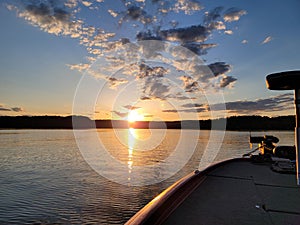 Sunset over watts bar lake. Front corner of bass boat and trolling motor photo