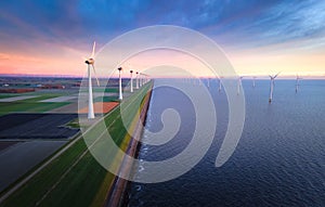 Sunset Over Wind Farm Along Coastal Dyke