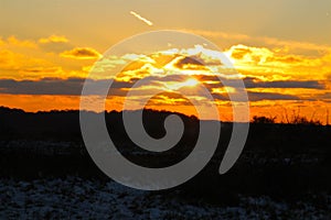 Sunset over winter meadow