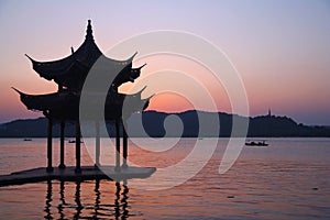 Sunset with a pagoda on the beautiful Hangzhou lake