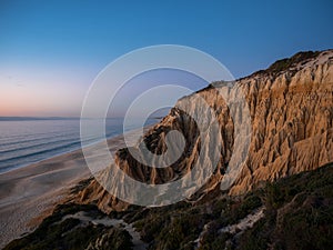 Sunset panorama of Arriba Fossil da Praia da Gale Fontainhas hoodoo fairy chimney earth pyramid rock formation Portugal