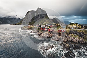 Sunset Panorama of famous tourist attraction Hamnoy fishing village on Lofoten Islands near Reine, Norway with red rorbu