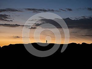 Sunset panorama of hiker on Marcahuasi andes plateau rock formations mountain hill valley nature landscape Lima Peru