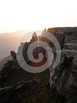 Sunset panorama hiker poncho on Marcahuasi andes plateau rock formations mountain hill valley nature landscape Lima Peru