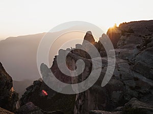 Sunset panorama hiker poncho on Marcahuasi andes plateau rock formations mountain hill valley nature landscape Lima Peru