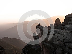 Sunset panorama hiker poncho on Marcahuasi andes plateau rock formations mountain hill valley nature landscape Lima Peru