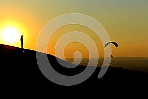 Sunset and paragliding photo