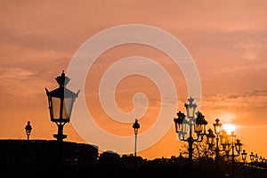 Sunset in Paris with silhouette of the luminaries. photo