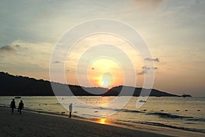 Sunset on Patong beach, reflected in the sea, against the backdrop of the mountains, Thailand