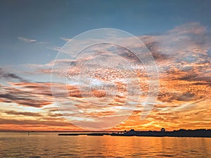 Sunset on Pensacola Bay with Blue Sky and Orange Clouds