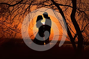 Sunset photo of silhouettes of a couple in love