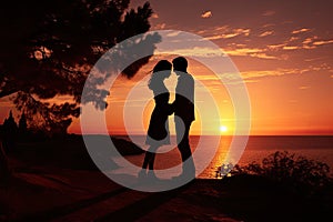 Sunset photo of silhouettes of a couple in love