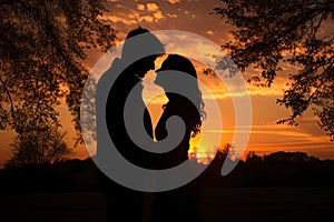 Sunset photo of silhouettes of a couple in love