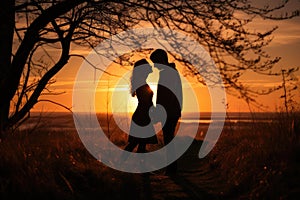 Sunset photo of silhouettes of a couple in love