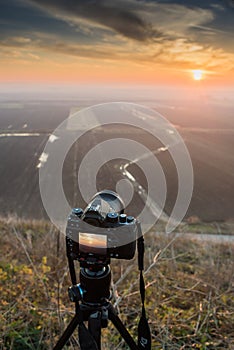 Sunset photography. Camera with tripod Sunset
