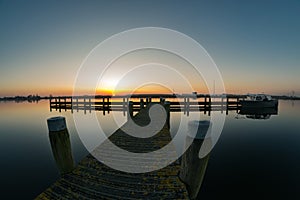 Sunset with pier near the River Rotte, Holland