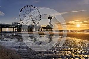 Sunset at The Pier in Scheveningen with waterreflection photo