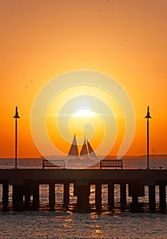 Sunset, pier, sea, sailboat, benches, Key West, Keys, Cayo Hueso, Monroe County, island, Florida photo