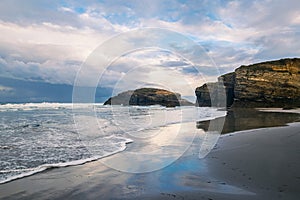 Sunset at Playa de las Catedrales Beach of the Cathedrals, Spain.