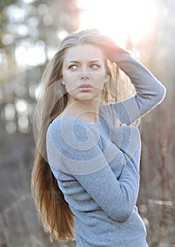 Sunset portrait of a pretty calm young woman