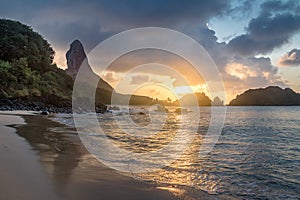 Sunset at Praia do Cachorro Beach with Morro do Pico on background - Fernando de Noronha, Pernambuco, Brazil photo