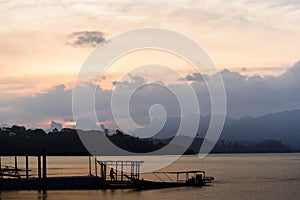 Sunset in lake with Siluate man and boat