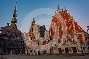 Sunset at Ratslaukums square with Saint Peter church and House o