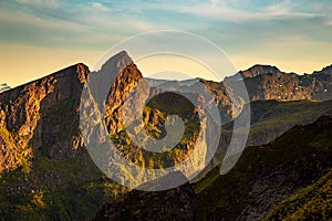 Sunset rays across a rugged mountain range in Norway