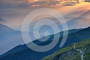 Sunset rays over hazy Pusteria valley Alto Adige Sudtirol Italy